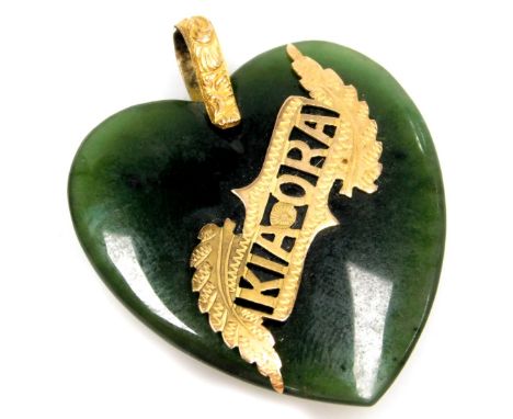 A jade heart shaped pendant, with applied "Kia-Ora" crest, with yellow metal mounts, unmarked, 3.5cm high, 11g all in. 