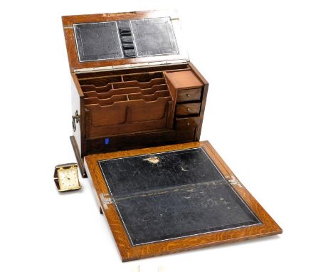 A Victorian oak and brass bound writing casket, the hinged lid and drop front opening to reveal a fitted interior, with drawe