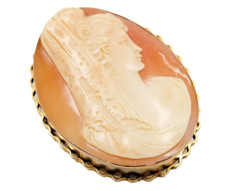 A shell cameo brooch, bust portrait of a lady in a mantilla, set in yellow metal, with safety chain as fitted. 