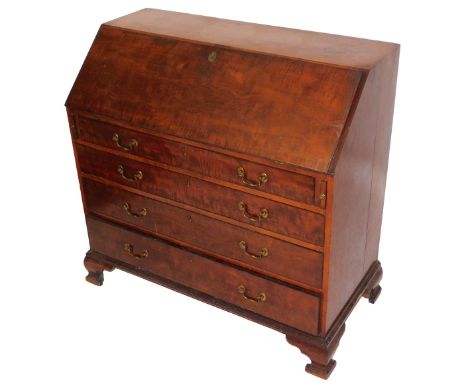 A George III mahogany bureau, the fall flap opening to reveal a central door flanked by eight recesses and six drawers, over 