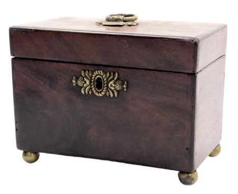 A George III mahogany tea caddy, with brass carrying handle and key escutcheon, opening to reveal twin lidded compartments, r
