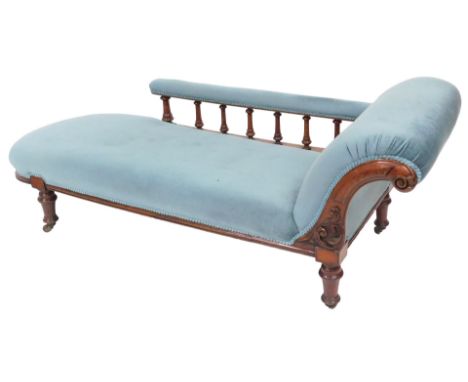 A Victorian mahogany chaise longue, upholstered in button back light blue draylon, raised on turned legs, on castors, 192cm w