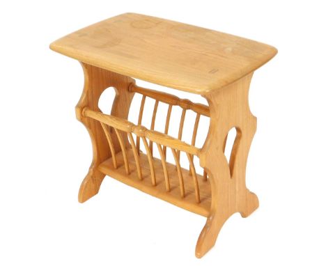 An Ercol Chaucer light elm magazine rack side table, raised on trestle end supports, 50cm high, 54cm wide, 36cm deep.