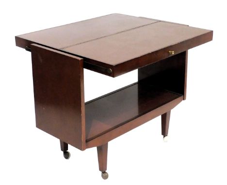 A mid century mahogany hostess trolley, with a central shelf/half table top, raised on tapering square legs on castors, 73cm 