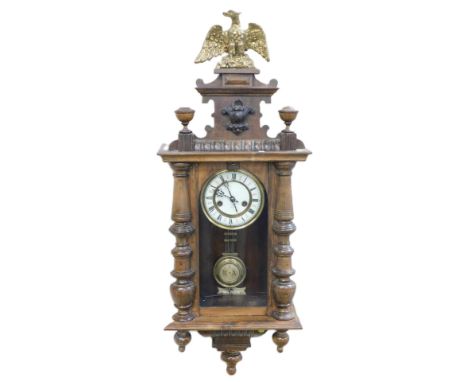 A late 19thC Continental oak cased wall clock, circular brass dial with enamel chapter ring bearing Roman numerals, eight day