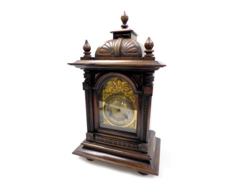 A Victorian oak cased mantel clock, the brass break arch dial with cherubs head and foliate spandrels, silvered chapter ring 