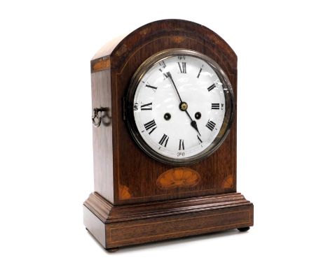 An Edwardian mahogany and inlaid mantel clock, circular enamel dial bearing Roman numerals, eight day movement with coil stri