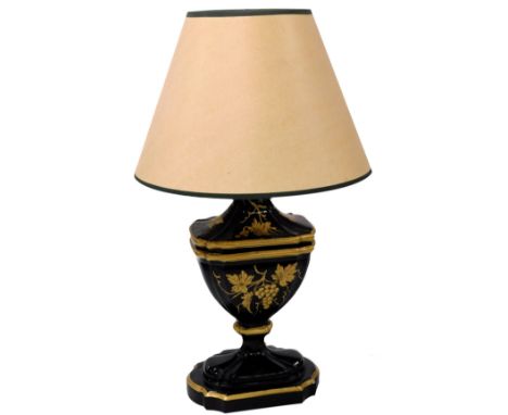 A Regency Toleware style ceramic table lamp, gilt decorated with vines on a black ground, with shade, 69cm high.
