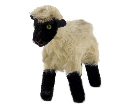 An early 20thC Steiff blacked face lamb, 15cm wide.