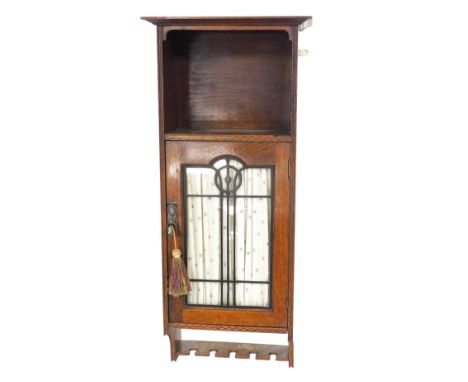 A Victorian oak Arts and Crafts style wall hanging cupboard, with a glazed door opening to reveal a shelf, 81cm high.