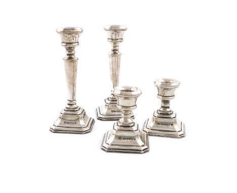 A pair of silver candlesticks and a matching pair of dwarf silver candlesticks, by L J Millington, the smaller pair by and Th