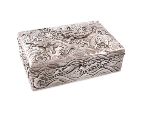 A Chinese silver box, rectangular form, the hinged cover embossed with a dragon within scroll waves, the sides with similar d