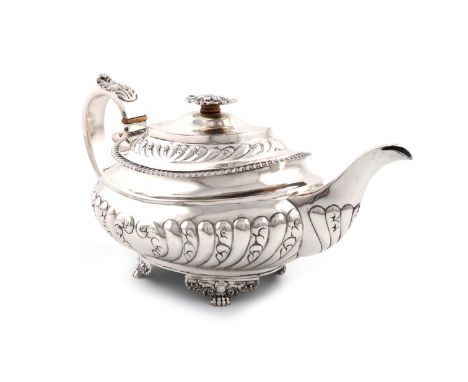 λA George IV silver teapot, by Thomas Death, London 1824, oblong bellied form, part-fluted and foliate decoration, leaf cappe