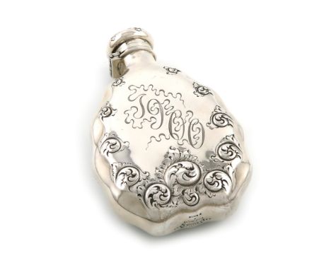 By Tiffany and Co., a 19th century American silver hip flask, 1891-1902, shaped oval form, chased foliate scroll decoration, 