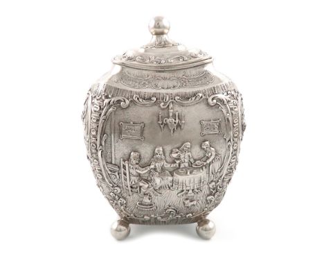 A German silver tea caddy, circa 1895, rounded tapering rectangular form, embossed with figural dining scenes, the pull-off c