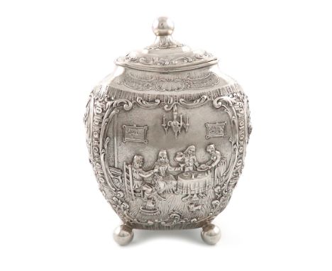 A German silver tea caddy, circa 1895, rounded tapering rectangular form, embossed with figural dining scenes, the pull-off c