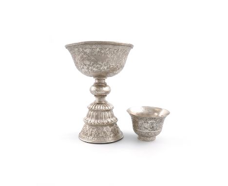 A Tibetan metalware butter lamp, circular form, chased decoration, on a knopped stem, on a raised circular foot, with fluted 