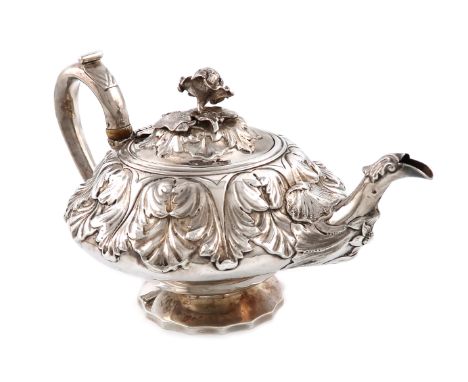 λA George IV silver teapot, by Charles Fox, London 1829, circular form, embossed foliate decoration, the scroll handle with i