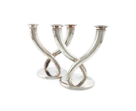 By Christofle, a pair of French electroplated two-light candelabra, tapering scroll arms, on raised circular bases, height 20