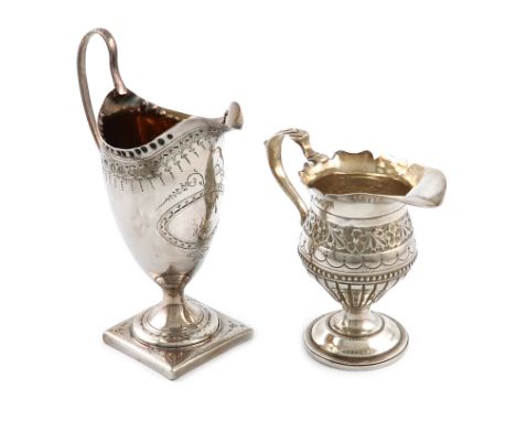 A George III silver cream jug, maker's mark worn, London 1787, helmet form, scroll handle, punch bead border, engraved decora