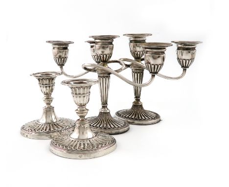 A pair of Edwardian dwarf silver candlesticks, by The Goldsmiths and Silversmiths Company, London 1901, oval fluted form, on 