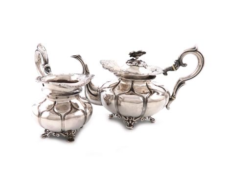 λA 19th century Dutch silver tea pot and cream jug, maker's mark of S &amp; Co., 1850, lobed circular bellied form, scroll ha