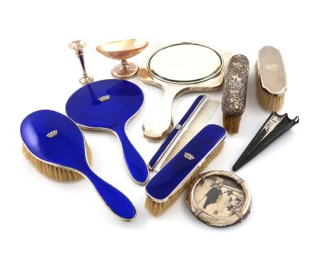 A mixed lot of silver dressing table items, including a four-piece silver and dark blue enamel dressing table set, Birmingham