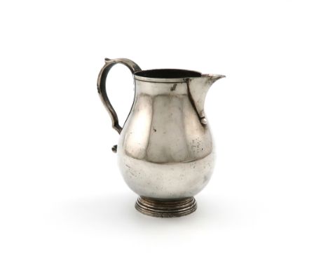 A modern silver sparrow-beak cream jug, by R. Comyns, London 1971, plain baluster form, scroll handle, on a circular foot, he