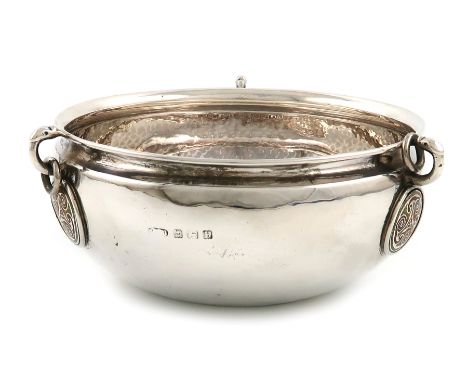 By A.E. Jones, a silver and enamel revivalist bowl, Birmingham 1932, circular form, with a central red and yellow enamelled C