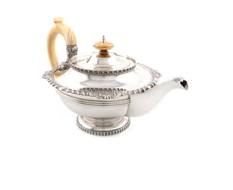 λA silver teapot, by Walker and Hall, Sheffield 1932, circular form, heavy gadroon and shell border, ivory scroll handle issu