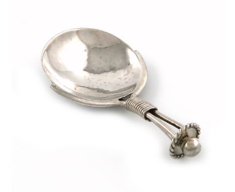 By A. E. Jones, an Arts and Crafts silver caddy spoon, Birmingham 1919, spot-hammered circular bowl, wire-work handle with a 