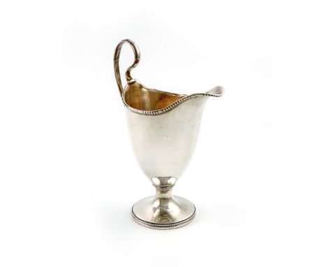 A George III silver cream jug, by Robert Hennell, London 1802, helmet form, beaded borders and scroll handle, on a raised cir