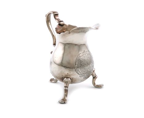 An 18th century silver cream jug, maker's mark only, possibly R*T, possibly American, baluster form, scroll handle, the front