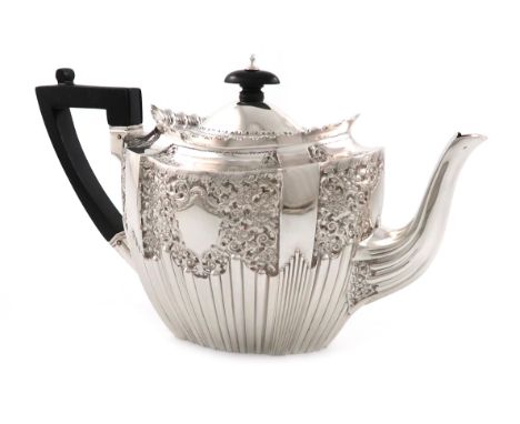 A late-Victorian silver teapot, by James Dixon and Sons, Sheffield 1895, shaped oval form, chased foliate decoration above pa