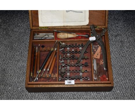 A vintage leather making kit, with punch and assorted tools.
