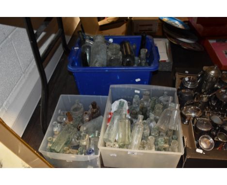 Two boxes of vintage and antique glass bottles, including medicine bottles and sauce bottles.