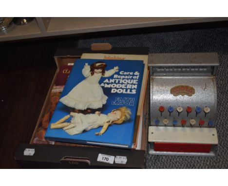 A vintage Codeg toy till and a selection of doll collectors books.