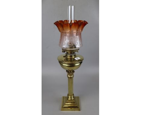 Brass oil lamp with amber glass shade by Hinks of Birmingham 