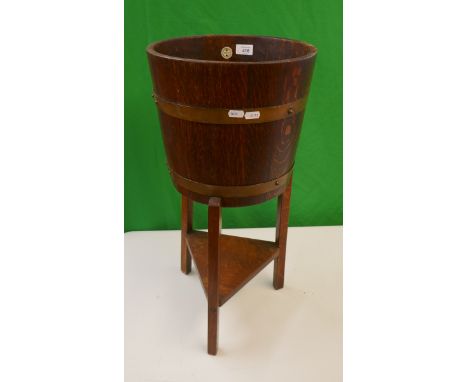 Brass bound barrel planter on legs 