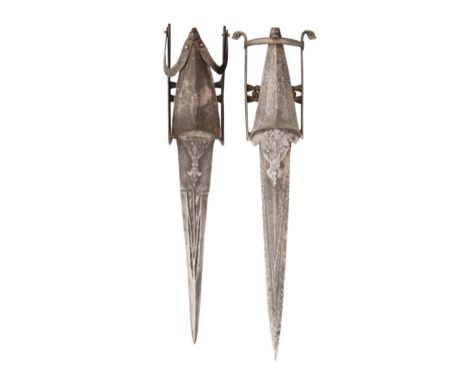 the first in excavated condition, with sharply tapering blade formed with a reinforced point, with pairs of converging fuller