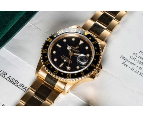 A FINE GENTLEMAN'S 18K SOLID YELLOW GOLD ROLEX OYSTER PERPETUAL GMT MASTER II BRACELET WATCHCIRCA 1991, REF. 16718 WITH ADDIT