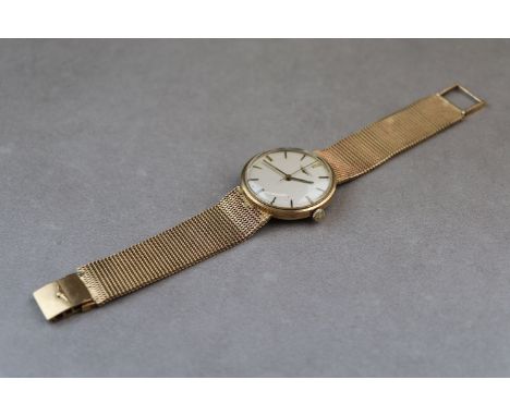 Gents 9ct Gold Gents Longines wristwatch with fixed 9ct Gold mesh strap, the silvered metallic dial has a sweep seconds hand 