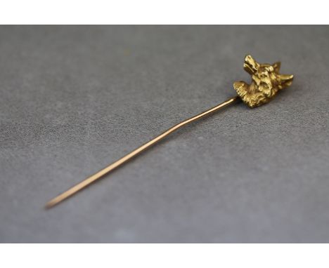 A fox head 18ct yellow gold stick pin, textured face, dimensions of head approximately 15mm by 12mm, pin also gold