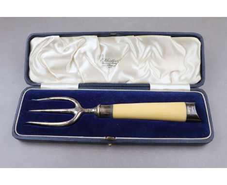 A Victorian cased silver bread fork with ivorine handle, silver prongs, collar and finial, tapered stem, makers Goldsmiths &a