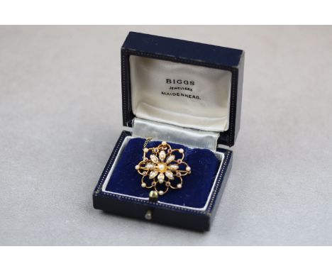 An Edwardian seed pearl and ruby 15ct yellow gold flower head brooch, the central flower motif full set with twenty-five seed