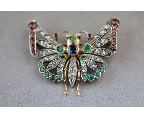 A sapphire, emerald, ruby and diamond 10ct yellow gold butterfly brooch, wings outstretched, the thorax set with centre rub o