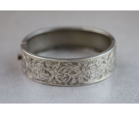 George VI silver hinged bangle with bright cut floral and foliate decoration to the upper half, makers Kenart Ltd, Birmingham