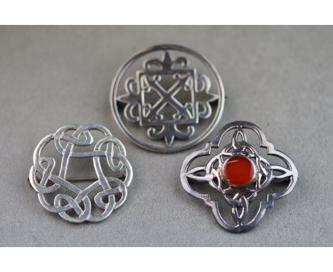 Three Celtic silver brooches to include carnelian silver brooch of quatrefoil form with central circular cabochon cut carneli