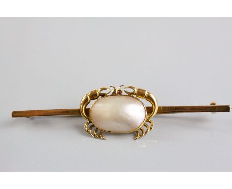 A late Victorian/Edwardian blister pearl and ruby yellow gold bar brooch in the form of a crab, the blister pearl forming the