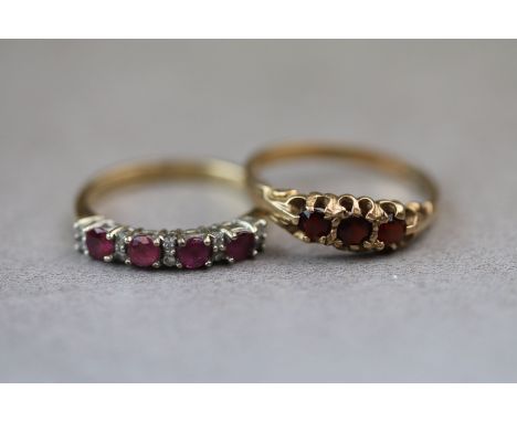 A three stone garnet 9ct yellow gold dress ring, three claw set round mixed cut garnets, ring size M½ together with a ruby an